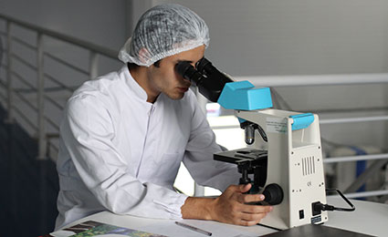 Technician with microscope